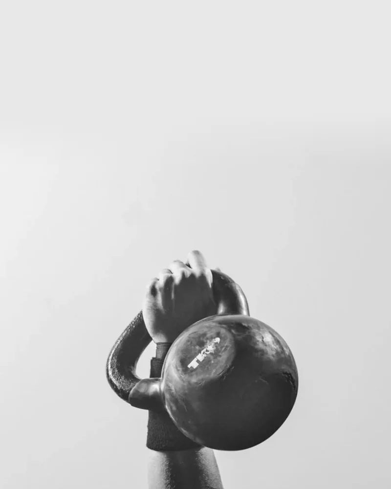 Kettlebell held over a pale background